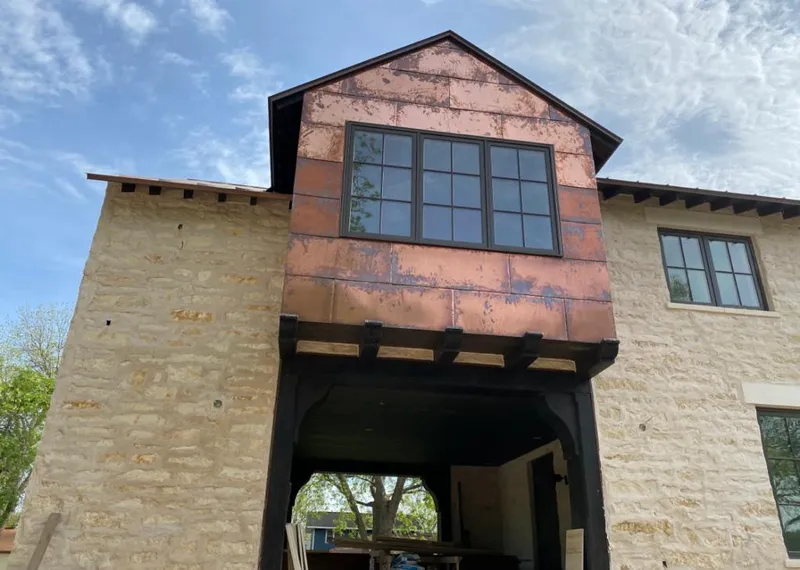 Copper metal panel facade on a stone building for Skylight Installation in Pittsboro
